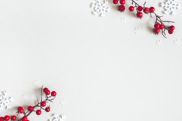 Christmas or winter composition. Snowflakes and red berries on gray background. Christmas, winter,...
