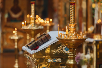 Background with a church theme. Candles burn in a golden candlestick.
