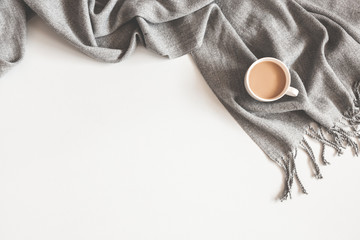 Christmas composition. Cup of coffee, scarf on gray background. Christmas, winter concept. Flat...