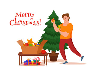 Happy boy decorating Christmas tree with toys, star and garland.