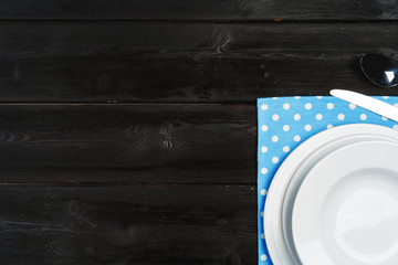 Obraz na płótnie Canvas Table setup with plates on dark wooden background