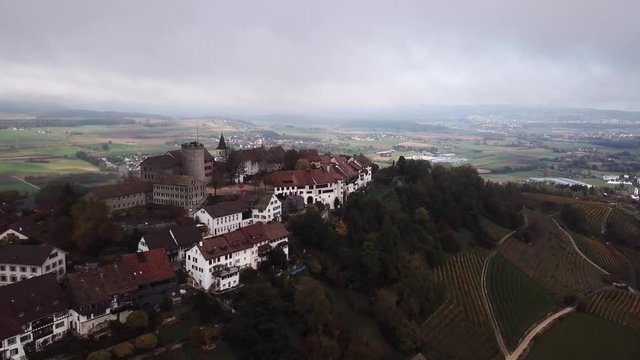 Aerial over the hilltop town of Regensberg in Zurich, Switzerland. Drone slow forward dolly
