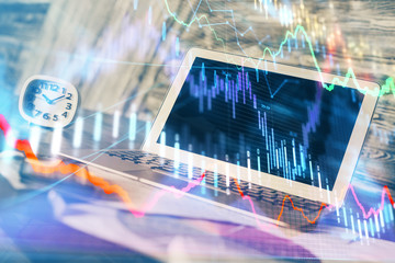 Financial graph colorful drawing and table with computer on background. Double exposure. Concept of international markets.