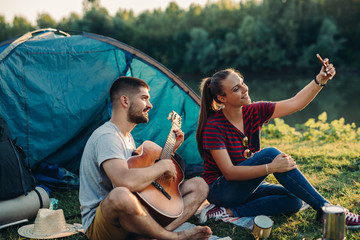 romantic couple on camping by the river outdoors