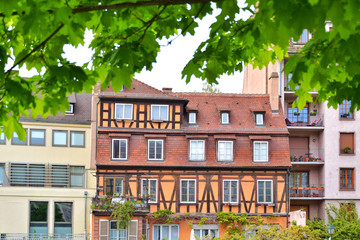 Fototapeta premium Strasbourg, France - May 2019. Traditional half-timbered houses in the center old city Strasbourg. Amazing colorful houses in La Petite France, Alsace. Beautiful view of the historic town Strasbourg