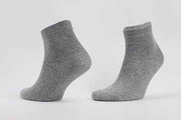 Grey black cotton short socks on invisible  foot as mock up for advertising, branding, design. Front and side view, sportwear template on white background.