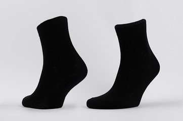 Blank black cotton socks medium size on invisible mannequin foot as mock up for advertising,...