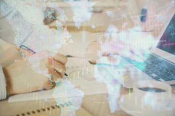 Obraz premium Multi exposure of stock market graph with man working on laptop on background. Concept of financial analysis.