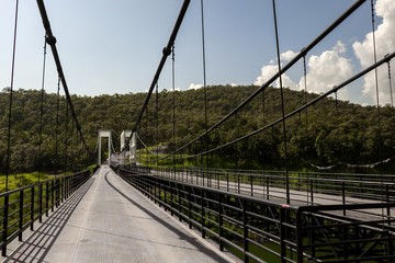 Fototapeta na wymiar Suspension Bridge surrounded by mountains at Mae Kuang Dam, Chiang Mai, Thailand