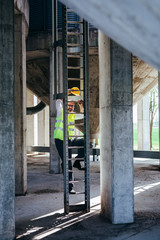 worker climbing on ladders on construction site © cherryandbees
