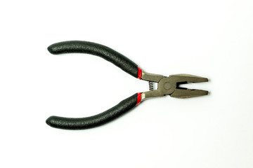 Obraz premium Close up of new pliers with plastic rubber handles black and red color isolated on white background.Electricial tool.Top view.
