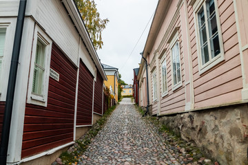 Fototapeta na wymiar Porvoo, Finland - 7 October 2019: Street of Old Porvoo, Finland. Beautiful city autumn landscape with colorful buildings.