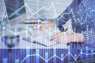 Double exposure of stock market chart with man working on computer on background. Concept of financial analysis.