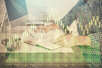 Double exposure of stock market chart with man working on computer on background. Concept of financial analysis.