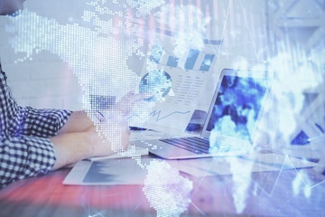 Multi exposure of financial graph with man works in office on background. Concept of analysis.