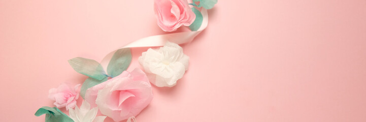 Fototapeta premium Greeting card with paper flowers on rose background.