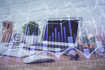 Financial market graph hologram and personal computer on background. Double exposure. Concept of forex.