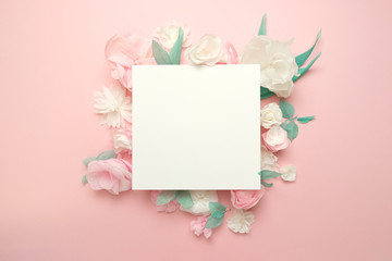 Greeting card with paper flowers on rose background.