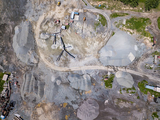 Aerial view of a small plant for the production and cleaning rubble and cement near the heaps of building materials, the tractors and trucks transports the finished product. Mining in quarry.