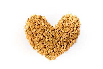Close up of uncooked rolled oats (oat flakes) shape form heart isolated on white background. Concept :Love healthy food ,Vegan food ,Raw food ,Valentine 's day.