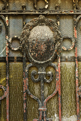 An old steel door. Details, structure and decoration of wrought iron with gates. An old iron wrought-iron grille of the entrance door