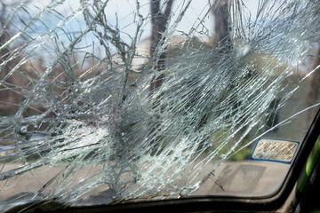 Broken car after an accident. Broken car glass. Broken windshield of car after collision. Robbers...