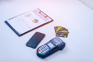 Graphs and credit cards placed on a white background Business planning concepts with good planning
