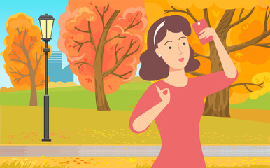 Woman communication with wireless device, female using phone. Girl standing in park with smartphone, internet connection, pretty lady outdoor, yellow autumn trees. Lady do selfie in autumnal park