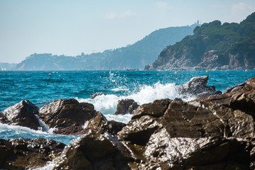 Fototapeta na wymiar sea wave splashes over stone