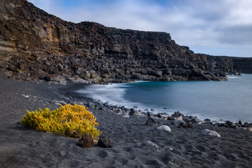 Fototapeta na wymiar Playa del Paso volcanic coastal path in Timanfaja National park near El Golfo