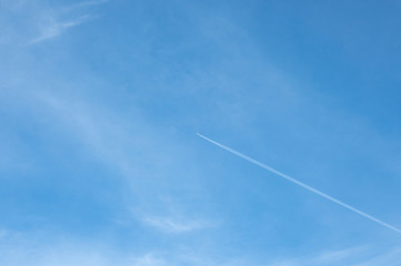 Aeroplane in flight showing its path with a vapour trail