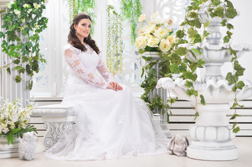 Fototapeta premium portrait of young beautiful bride in white dress posing