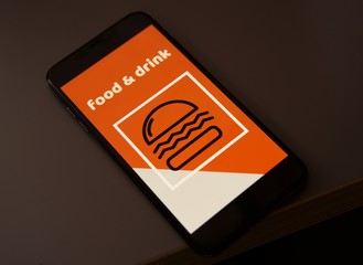 Close upatt  mobile phone with order food online on screen , food and restaurants applications        