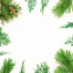 Fototapeta na wymiar Christmas winter frame of evergreen tree branches on white background. New Year background. Flat lay