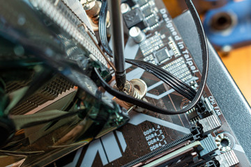 Installing a cooler on a personal computer processor. The process of upgrading computer maintenance in a service.