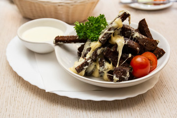 Beer snack of bread toast with garlic, cheese and sauce