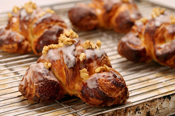 Fresh croissant  with nuts and icing in the cake shop