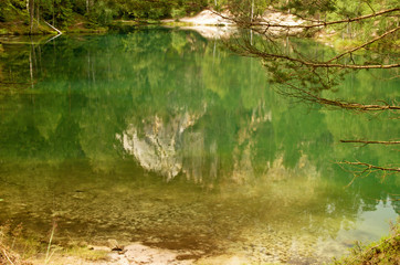 clear lake in Adrspach with reflection of surroundings