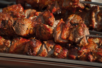 Barbecue fries in the coals. Meat and beef at the field kitchen festival.