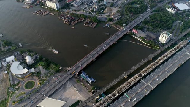 Thailand aerial flyover with downwards pan onto freeways and bridges with traffic and boats