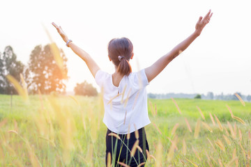 Young woman raise hands up for her success, Concept of Success in life.