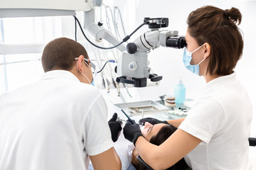 Two dentists making treatment in modern dental clinic
