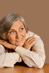 portrait of happy senior woman at table