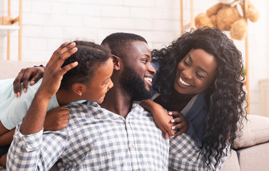 Black man spending time with wife and daughter at home