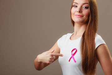 Woman wih pink cancer ribbon on chest