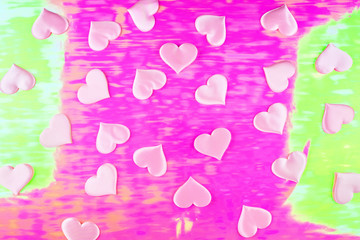 Fototapeta na wymiar Beautiful silk pink hearts on a holographic pink background. Holiday concept Valentine Day. Plase for text . Flat lay.