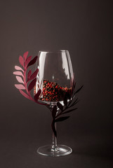 The decorated wineglass on a dark background. Design mockup
