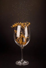 The decorated wineglass on a dark background. Design mockup