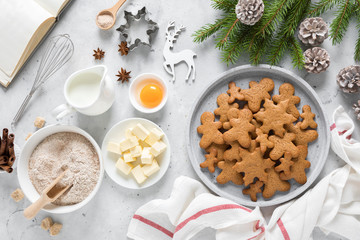 Christmas baking culinary background. Xmas gingerbread on kitchen table and ingredients for cooking festive cookies. New Year holiday decorations