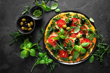 Pizza. Traditional italian pizza with green basil pesto sauce, top view